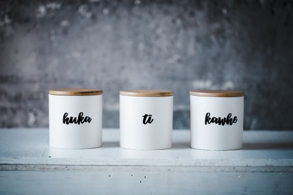 Taputapu sells household items like mugs and containers with te reo Māori labels on them