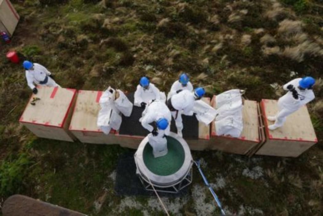 Loading a bait hopper.