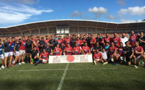 The New Zealand Defence Force rugby team alongside France following their third-place playoff match in Japan.