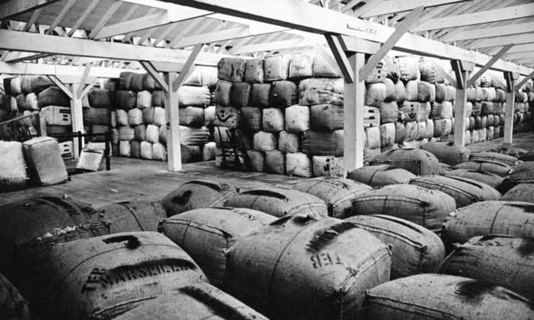 Bales of wool stacked in a wool store. Dominion post (Newspaper): Photographic negatives and prints of the Evening Post and Dominion newspapers. Ref: EP-Trade and Commerce-Wool and Wool prices-01. Alexander Turnbull Library, Wellington, New Zealand. /records/22328992