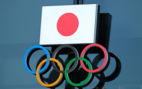 (FILES) In this file photo taken on November 15, 2020 the logo of the Japanese Olympic Committee is displayed at an entrance of the Japan Olympic Museum in Tokyo.