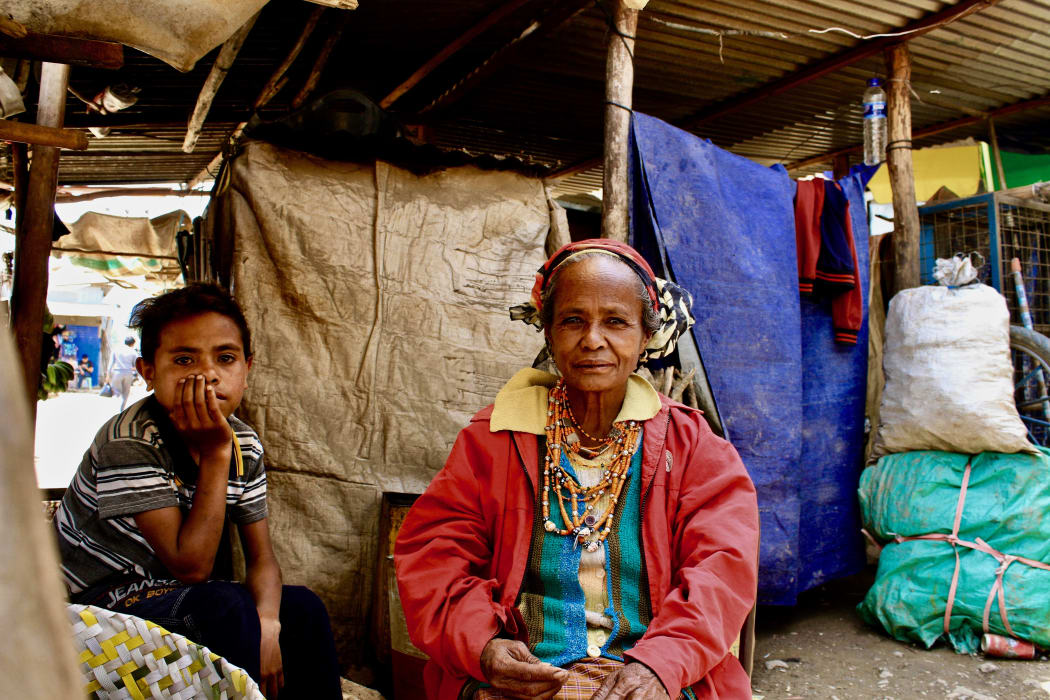 Timorese woman and her grandson at the markets
