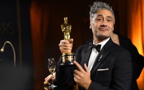 New Zealand director/actor Taika Waititi (R) waits as his award for Best Adapted Screenplay for "Jojo Rabbit" is engraved as he attends the 92nd Oscars Governors Ball at the Hollywood & Highland Center in Hollywood, California on February 9, 2020. (Photo by VALERIE MACON / AFP)
