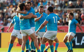 Uruguay's players celebrate after winning the Pool D match against Fiji in the 2019 Rugby World Cup Japan