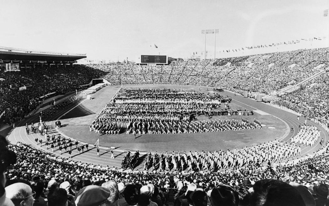 Picture taken on October 10, 1964 at Tokyo showing a general view of the stadium of the Olympic Games with the national delegations parading during the opening ceremony.