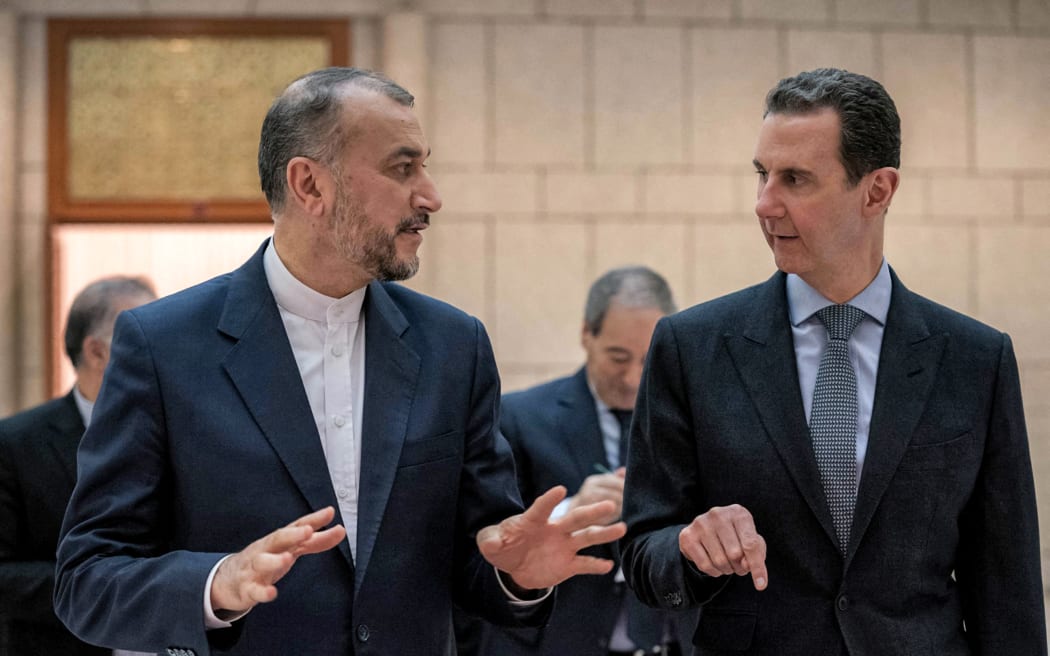 This handout picture released by the Syrian Presidency on 9 March, 2023 shows Syria's President Bashar al-Assad (right) meeting with Iran's Foreign Minister Hossein Amir-Abdollahian in Damascus.