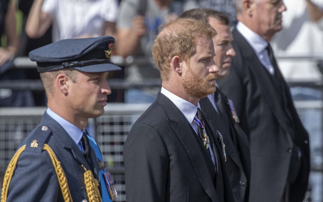 William, Prince of Wales (L) and Prince Harry, Duke of Sussex walk behind the coffin of Queen Elizabeth II, borne on gun carriage, during a ceremonial procession from Buckingham Palace to Westminster Hall in London, United Kingdom on 14 September 2022.