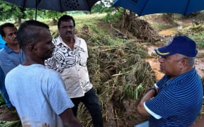 Residents of Yalalevu talk to Fiji Prime Minister Frank Bainimarama following the flood.