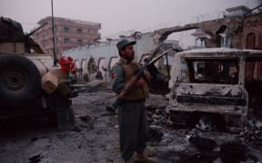 Afghan security forces inspect the site of attack on British charity Save the Children office in Jalalabad on January 24, 2018.
