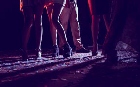Legs of dancing people dancing at a party.