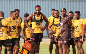 PNG coach Michael Marum, (in black), takes his players through their paces