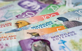 Pile of New Zealand currency laying flat on table