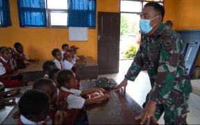 Indonesian military officer addresses a school class in West Papua, September 2021