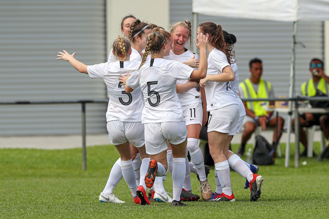 New Zealand's Kelli Brown (facing) celebrates scoring the opening goal of the match.