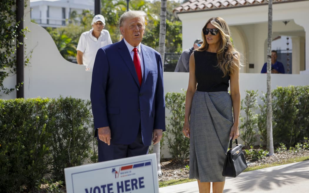 Former US President Donald Trump and former US First Lady Melania Trump speak to the media while departing a polling station after voting in the US mid-term elections at Morton and Barbara Mandel Recreation Center in Palm Beach, Florida.