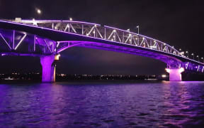 Auckland's Harbour Bridge before sunrise, getting lit up for Matariki.