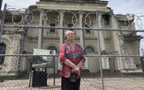 Anna Crighton, chair of Christchurch Heritage Trust,  in front of Christchurch's earthquake damaged Catholic Cathedral of the Blessed Sacrament