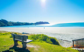 Beautiful view from top in a Waiheke Island, New Zealand with a beautiful blue sky and a white sand in a sunny day.