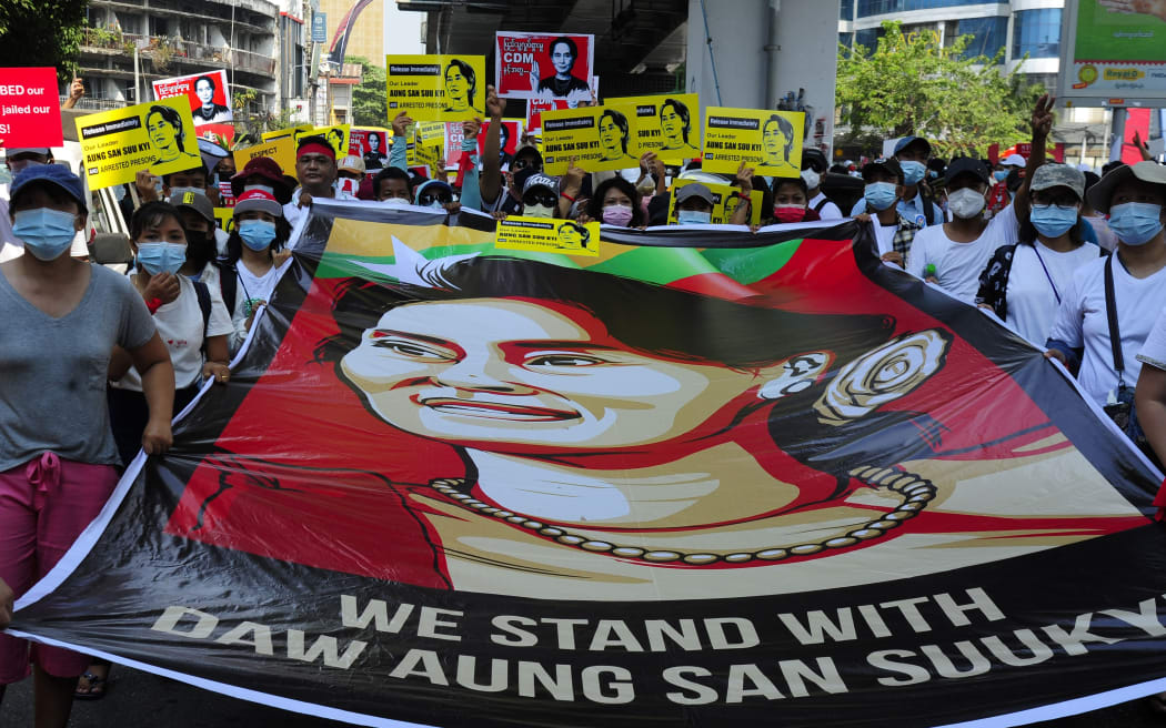 YANGON, MYANMAR - FEBRUARY 20: Anti-coup protesters hold picture of deposed leader Aung San Suu Kyi as they protest against the military coup Saturday, February 20, 2021, in Yangon, Myanmar.