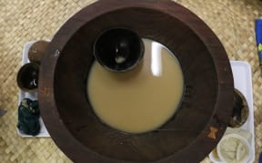 A tanoa (kava bowls) with a bilo (kava cup). Normally the lowliest person would serve kava to the circle.