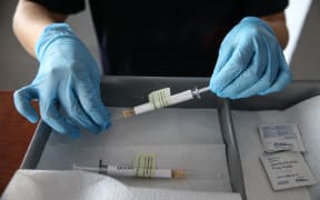 A health care worker holds an injection syringe of the phase 3 vaccine trial, developed against the novel coronavirus pandemic by the US Pfizer and German BioNTech company, at the Ankara University Ibni Sina Hospital in Ankara, Turkey on October 27, 2020.
