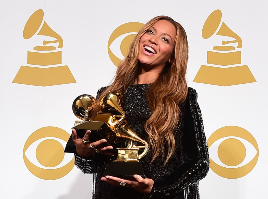 Beyoncé poses with her three Grammys during the 57th annual Grammy Awards in 2015.