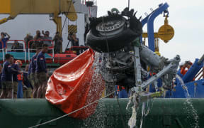 An Indonesian rescue team lift a pair tires from the ill-fated Lion Air flight JT 610 off Karawang in the Java Se