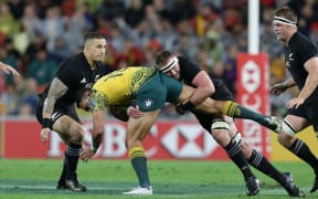 Australia's Israel Folau  is tackled by New Zealand's Sonny Bill Williams, left, and Kieran Read, right.