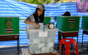 A woman casts her ballot at a polling station in Bangkok on March 24, 2019, during Thailand's general election.