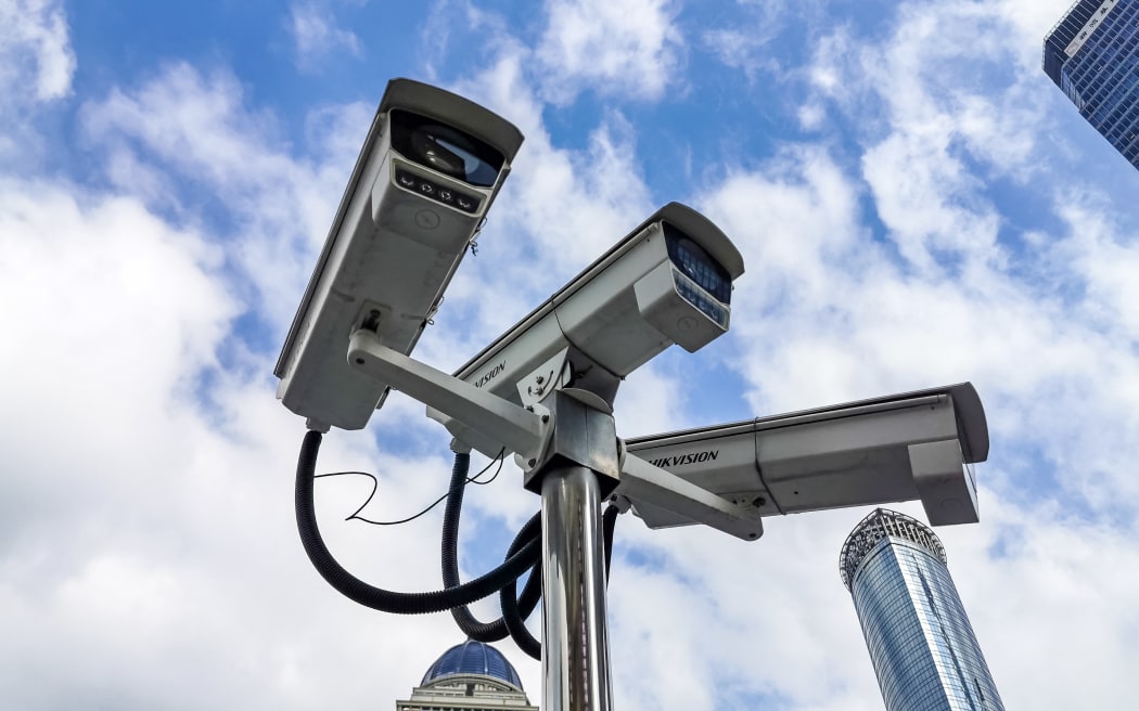 Many monitors produced by Hikvision, a Chinese manufacturer and the world's largest supplier of video surveillance products, are seen at local central business district with the landmark, Oriental Pearl Radio & Television Tower, as background, at the Bund, Shanghai, China, 28 November 2019. (Photo by Wang Gang / Imaginechina / Imaginechina via AFP)