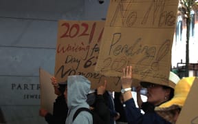 Hundreds of Chinese took to Auckland's Queen St on Sunday (12 November, 2023) to protest against National Security Check delays their Resident Visa applications.