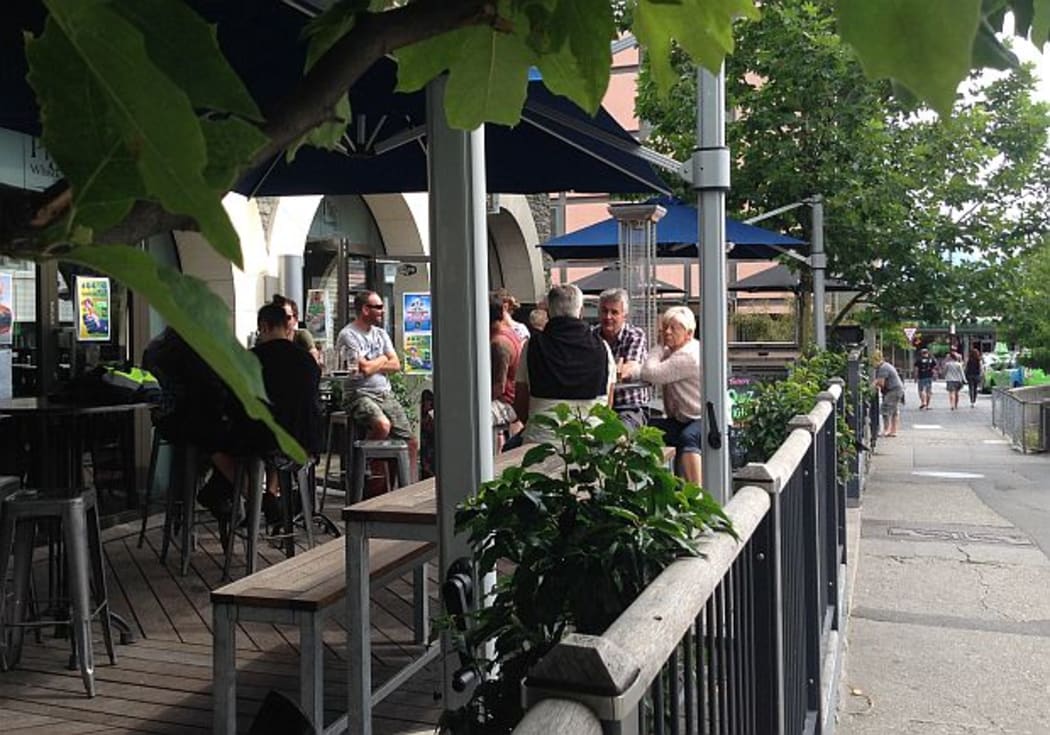 Patrons sit outside at a bar in Queenstown