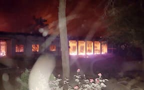 A photo released by MSF showing fires burning in part of the hospital which was hit after an air strike.