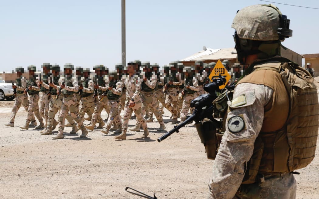 A New Zealand Defence Force protection soldier observes ISF troops. Iraq 2015