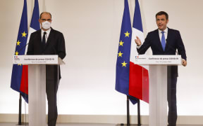 French Health Minister Olivier Veran (right) and French Prime Minister Jean Castex at a media conference in Paris, announcing the changeover of several departments to "maximum alert" and new curfew measures in order to curb the spread of the Covid-19.