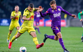 Jaushua Sotirio of the Phoenix in possession  with Kristian Popovic of the Glory looking to contest during the A-League match,  Perth Glory v Wellington Phoenix at Bankwest Stadium, Wednesday 22nd July 2020 Copyright Photo: David Neilson / www.photosport.nz