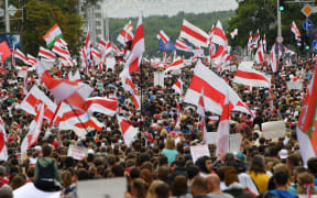 Protesters hold flags during demonstration against police violence following recent protests to reject the presidential election results, in Minsk, Belarus.