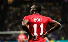 Usain Bolt playing football.