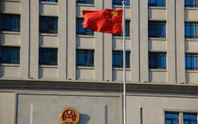 A flag flies in front of a court house in Shangdong Province, China.