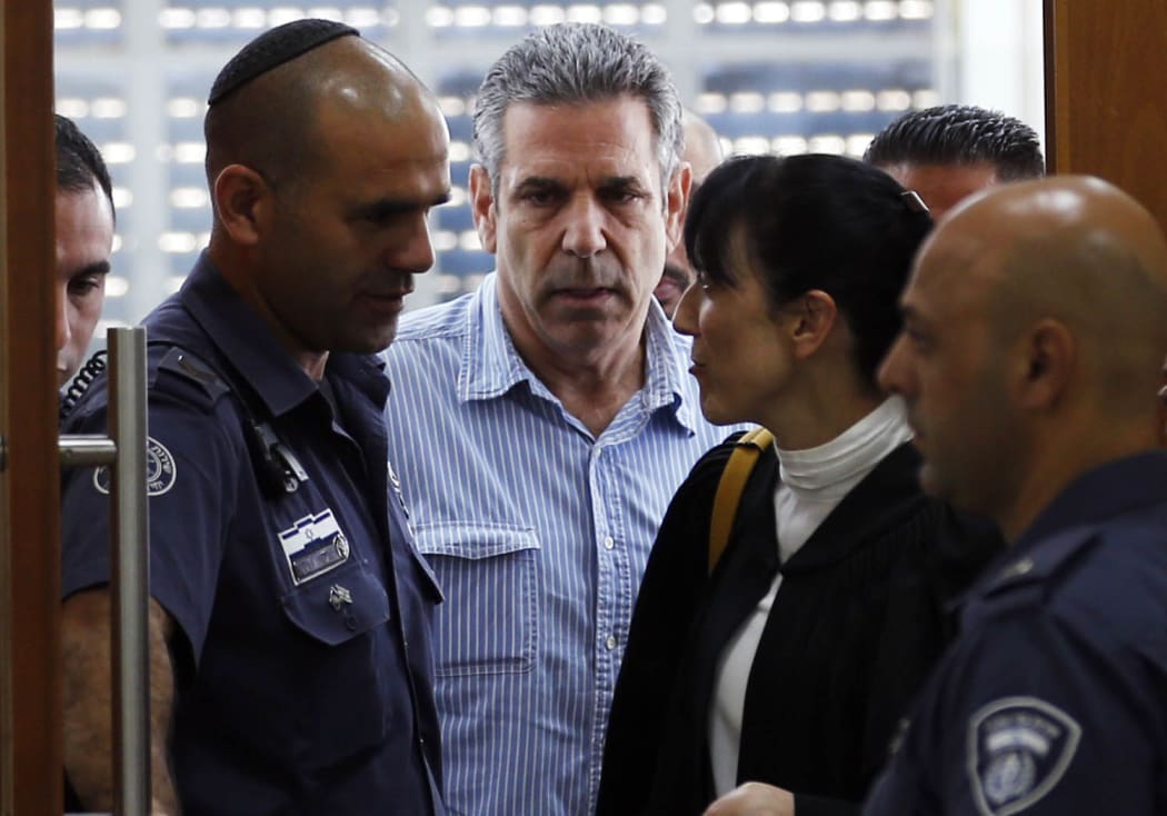 In this file photo taken on July 05, 2018 Gonen Segev (C), a former Israeli cabinet minister indicted on suspicion of spying for Iran, is seen in court in Jerusalem.