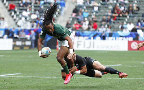 South Africa's Cecil Afrika is caught by New Zealand's Ngarohi McGarvey-Black during their semi-final win