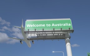 Airplane flies over highway sign