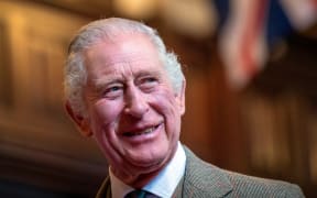 Britain's King Charles III reacts as he meets with families from Afghanistan, Syria and Ukraine who have settled in Aberdeen, during a visit to Aberdeen Town House, on October 17, 2022. (Photo by Jane Barlow / POOL / AFP)