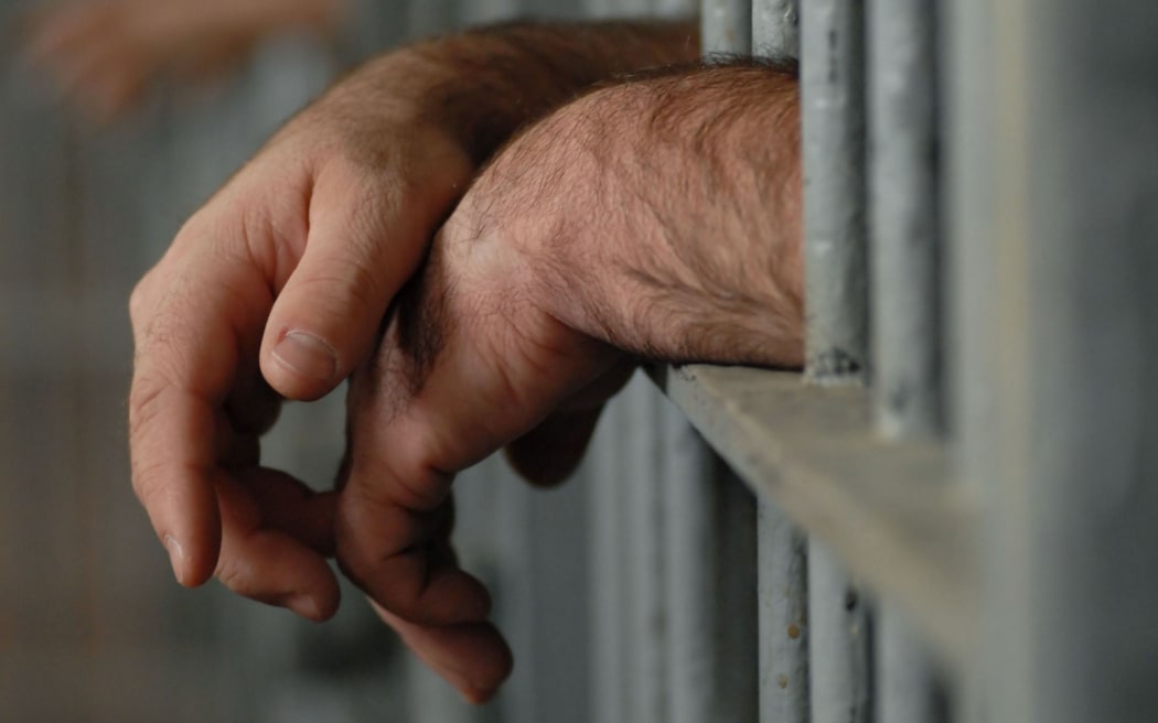 Prison bars, hands, generic