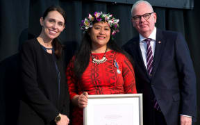 Matalena Leaupepe, (centre), is presented with her Public Service Medal by PM Jacinda Ardern and State Services Commissioner, Peter Hughes