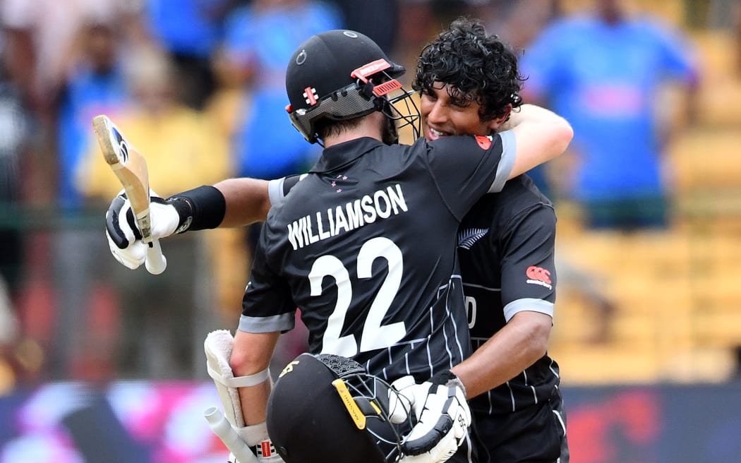 New Zealand's batsman Rachin Ravindra celebrates his century with captain Kane Williamson during their World Cup group match against Pakistan.