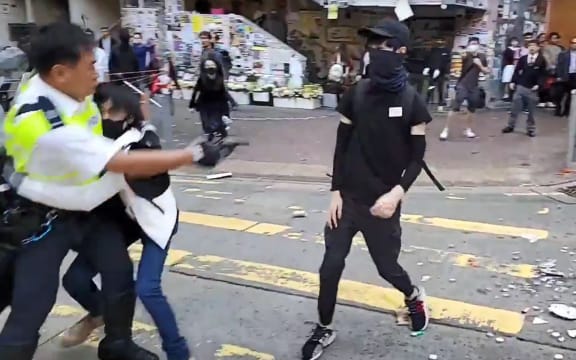 A video grab taken from Cupid News on 11 November, 2019 shows a police man (L) shooting a pro-democracy protester in the chest during a protest in Sai Wan Ho district, in Hong Kong.