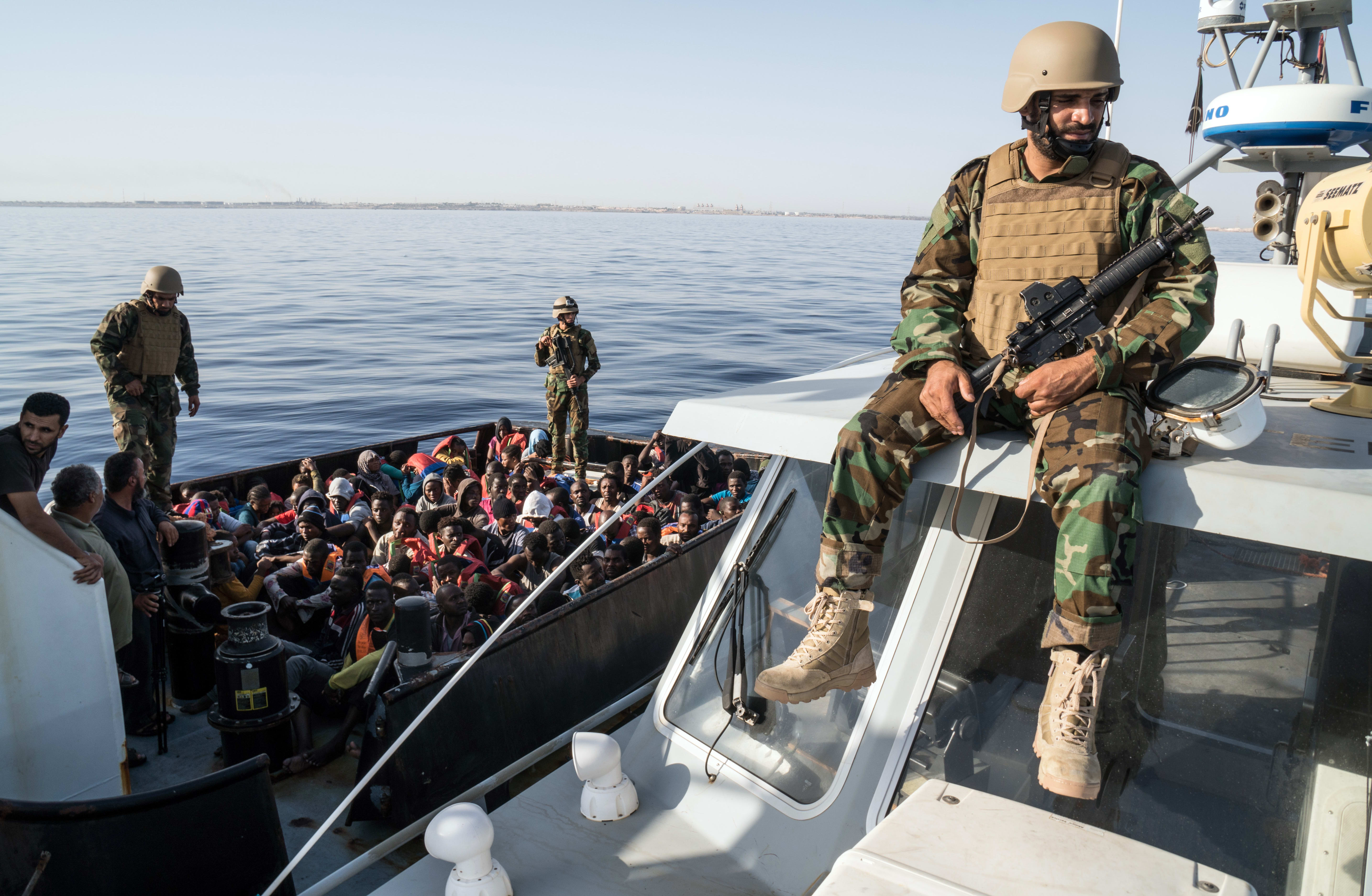 A Libyan coast guardsman watches over during an operation to rescue illegal immigrants who attempted to reach Europe off the coastal town of Zawiyah, 45 kilometres west of the capital Tripoli, on June 27, 2017.