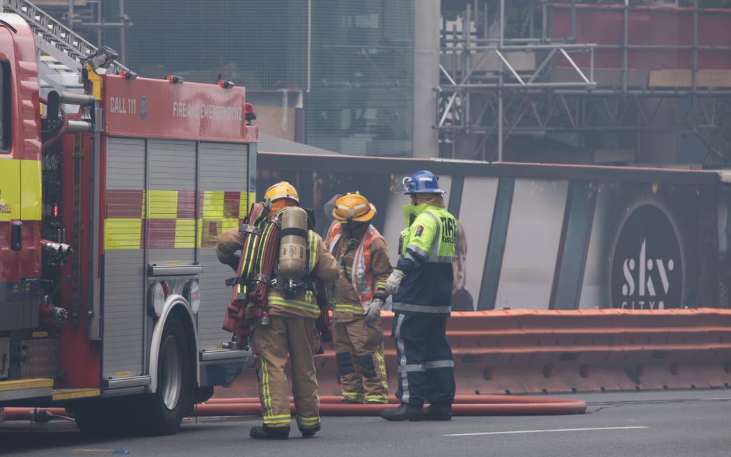 Firefighters gather around SkyCity convention centre where a fire has broken out.