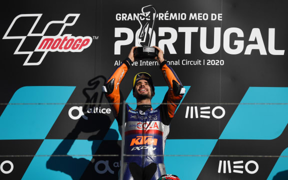 Red Bull KTM Tech 3's Portuguese rider Miguel Oliveira celebrates on the podium after winning the MotoGP race of the Portuguese Grand Prix at the Algarve International Circuit in Portimao on November 22, 2020.
